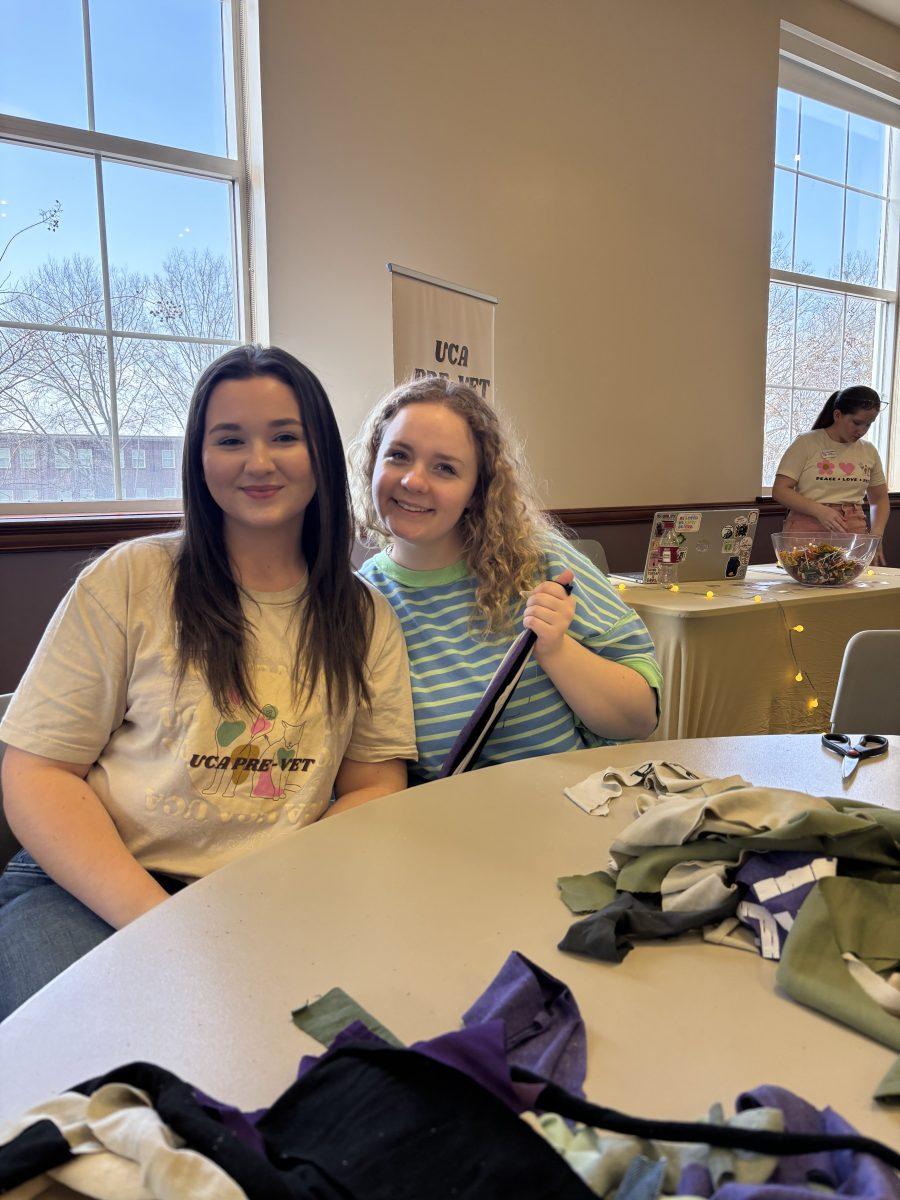 (Left) Emma Bullard and (Right) London White pose for a picture while making pet toys. The eventtook place in the Student Center.