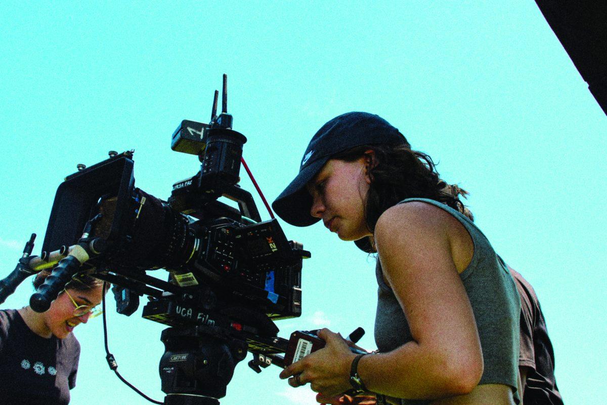 (Top) Skylar Nelsen works with film equipment on the set of “Racoon Soup.” (Bottom) Nelsen reads her schedule on set.