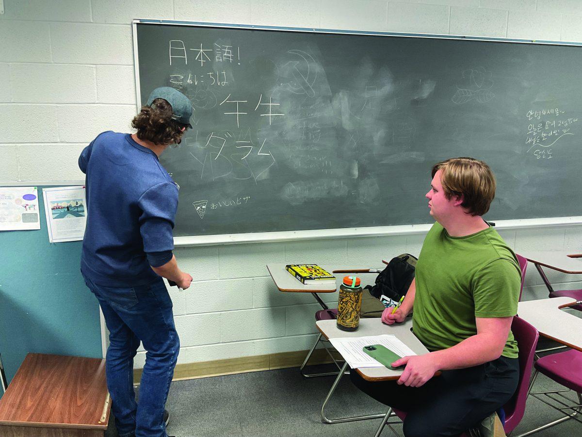 Senior Tyler Nicholson writes Japanese vocabulary on the board. Theclass takes place during x-period in Irby Hall room 312.