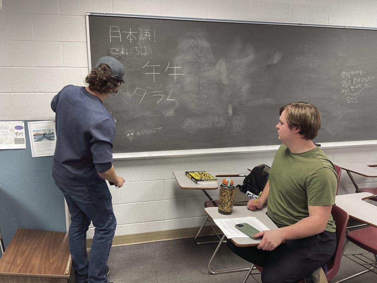 Senior Tyler Nicholson writes Japanese vocabulary on the board. The
class takes place during x-period in Irby Hall room 312.