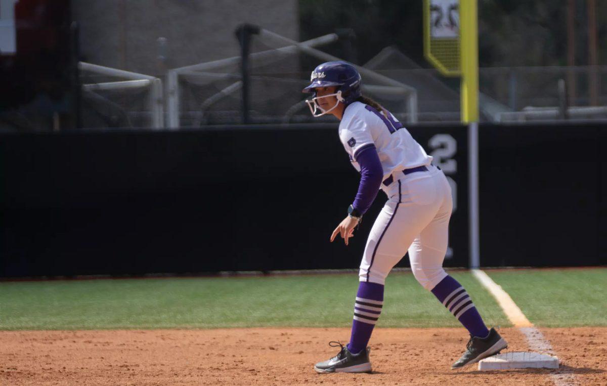 Freshman infielder Mya January watches from first base for a hit, preparing to steal second base. The Bears won one out of four games at the Rajin' Cajun Invitational, emerging victorious against Sam Houston State 2-1. 