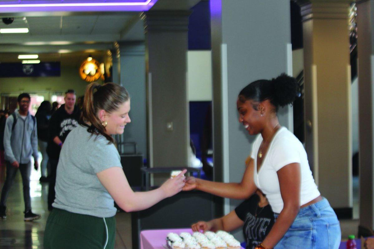 (Right) Junior Jiya Adams gives (left) freshman Maci Jordan a cupcake. Hosted by Real Beauty, the goal of
this event was to spread kindness.