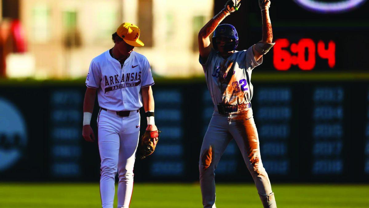 Freshman infielder Nathan Negre celebrates after stealing second base. Negre scored one run and had two hits against the Razorbacks March 11.