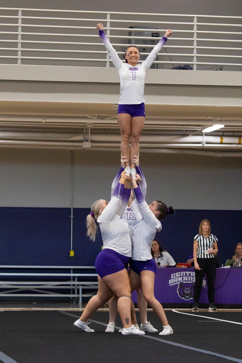 Senior flyer/tumbler Crystal Vuong performs an extension at the STUNT competition in the HPER center March 7. This was UCA's first time hosting a tournament this season.