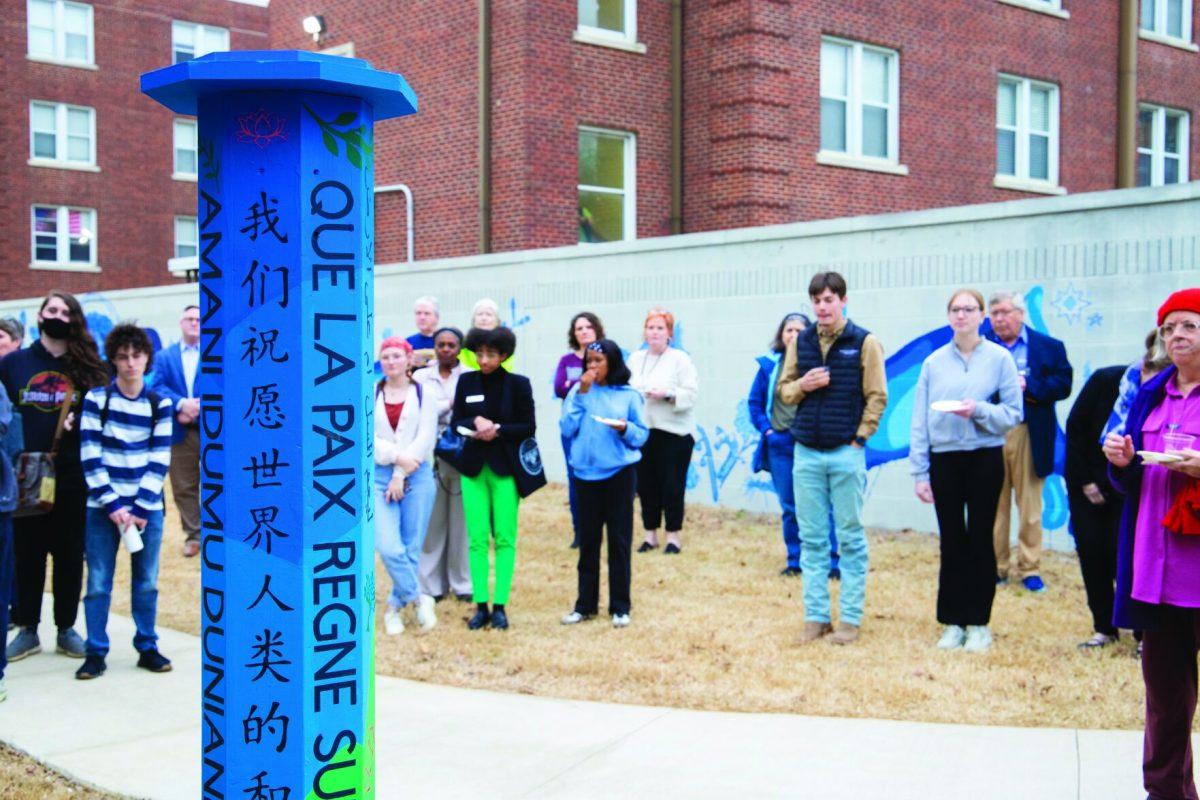 Students gather around the peace pole outside of Schichtl Hall.