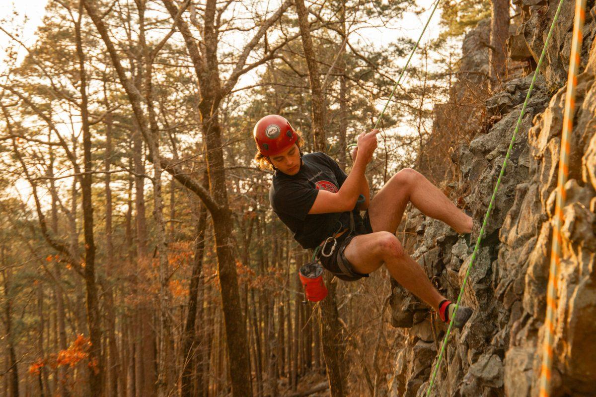 Grady Morriss repels down after climbing a route at Rattlesnake Ridge. The climbing class was taught by Frontier Climbing Company.