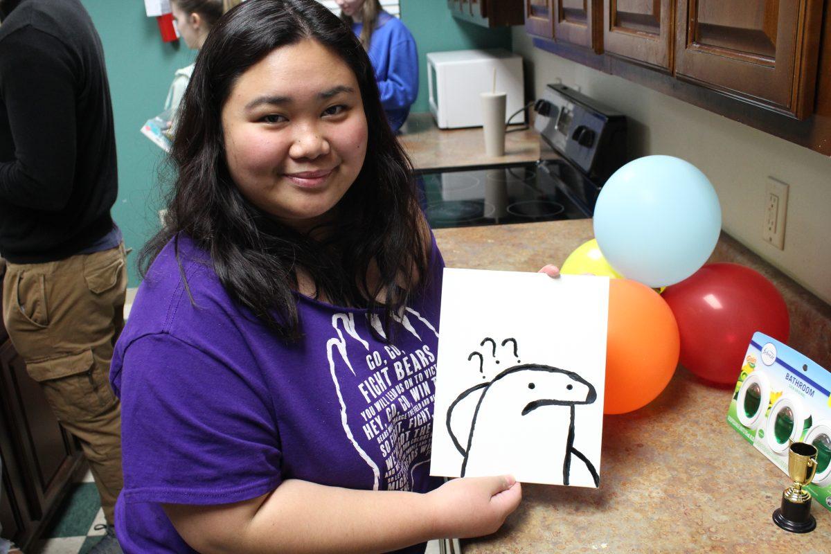 Sophomore Martha Gruray holds her winning art piece. Participants competed to create bad art.