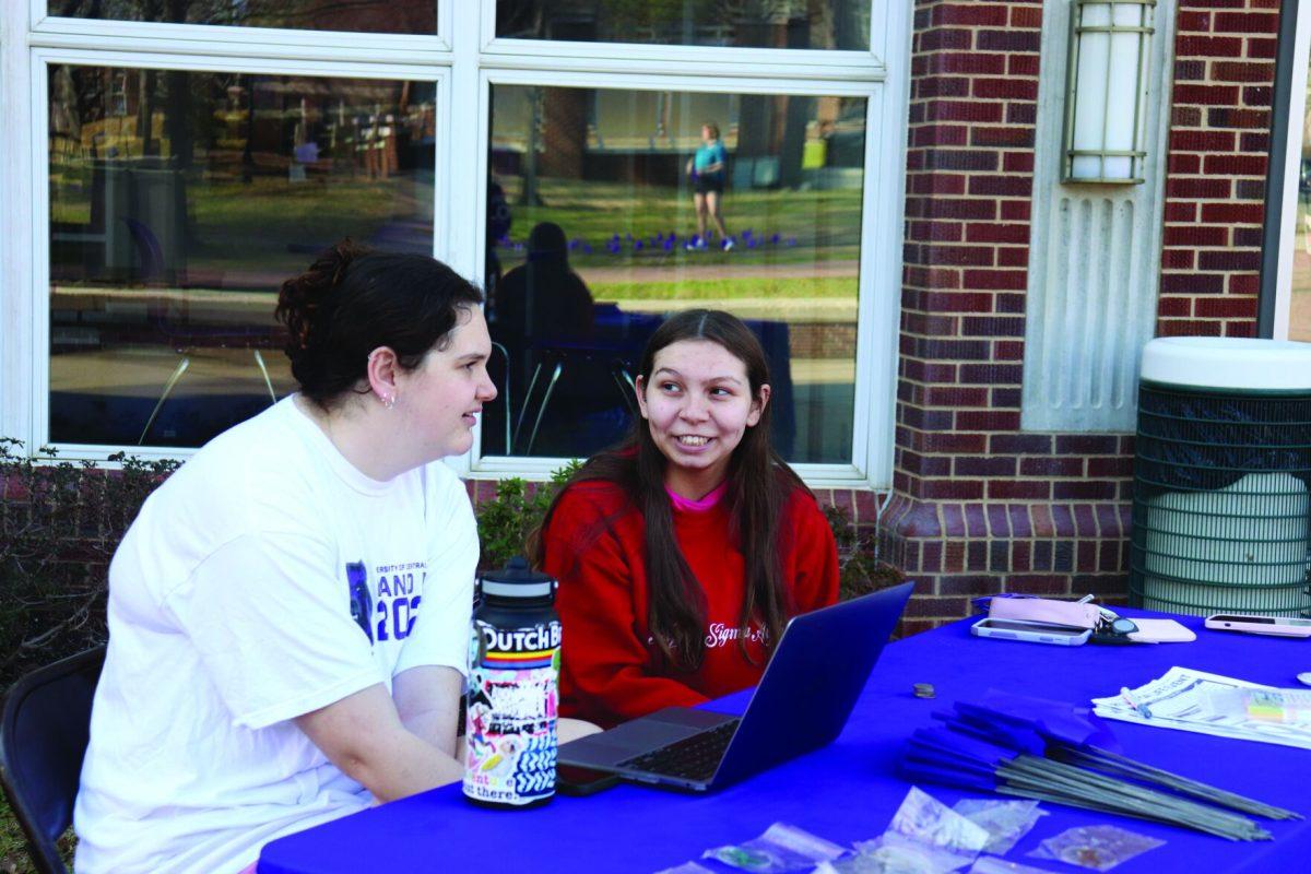 Relay for Life members wait for students to come to their table to buy keychains and flags. Relay for Life will be hosting a 5k run on April 5.