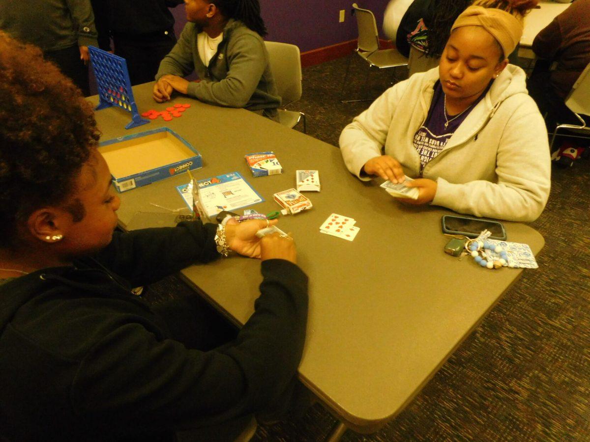 Freshman Mi’Kyla Bean and freshman Ronee Calloway playing a game called “smack.” Students were able to play multiple board games, card games and more.