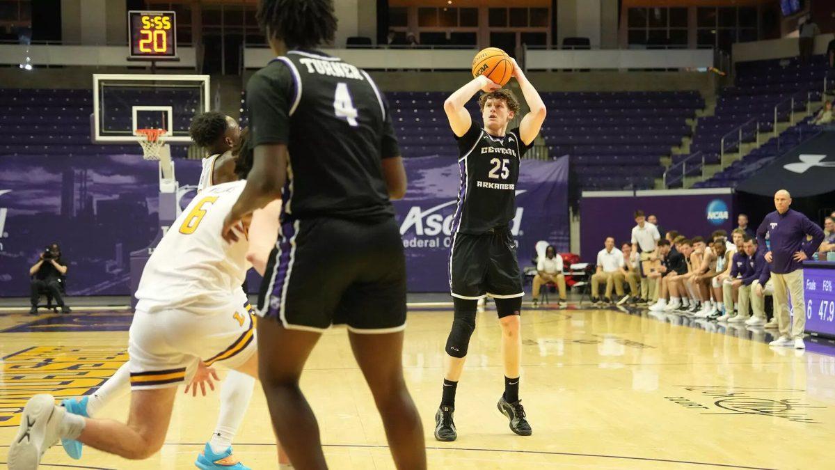 Senior guard/forward Elias Cato shoots for 3 points against the Bisons. Cato scored 10 points and had 6 rebounds for the Bears.
