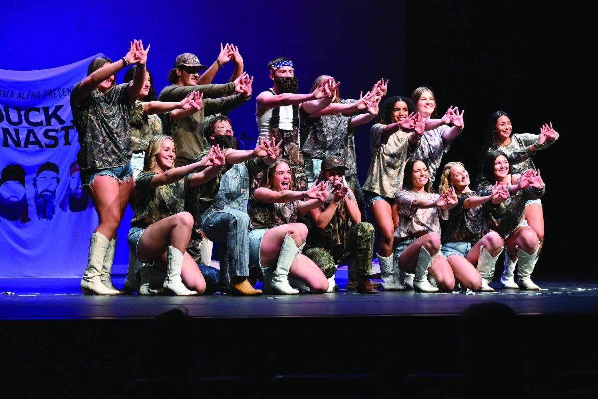 A group of Greek life members dance.