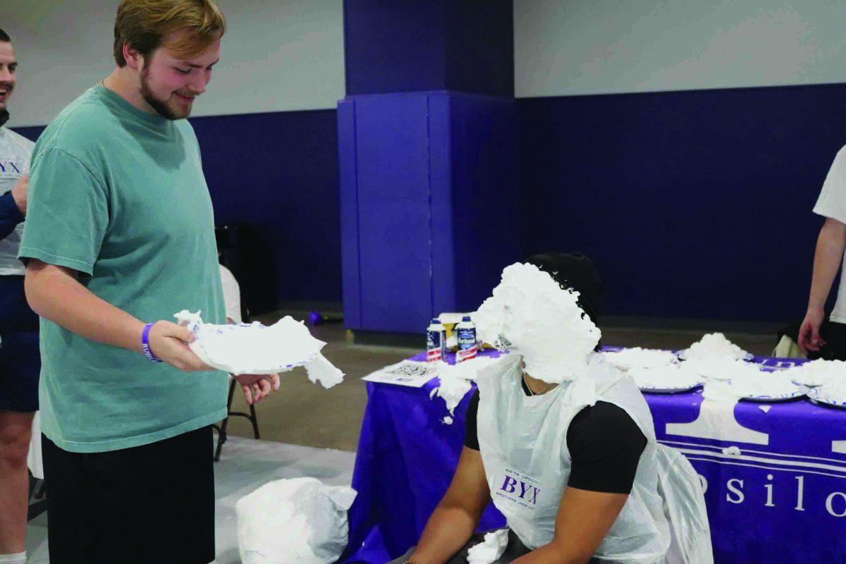 Sophomore David Faucett pies Quan Robinson in the face.