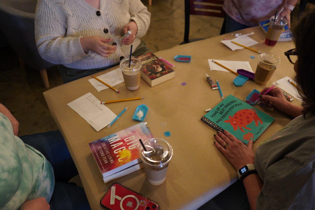 Event participants used creativity and individuality to craft bedazzled books. Guests got to freestyle on a book of their choice. (photo by Gabe White)