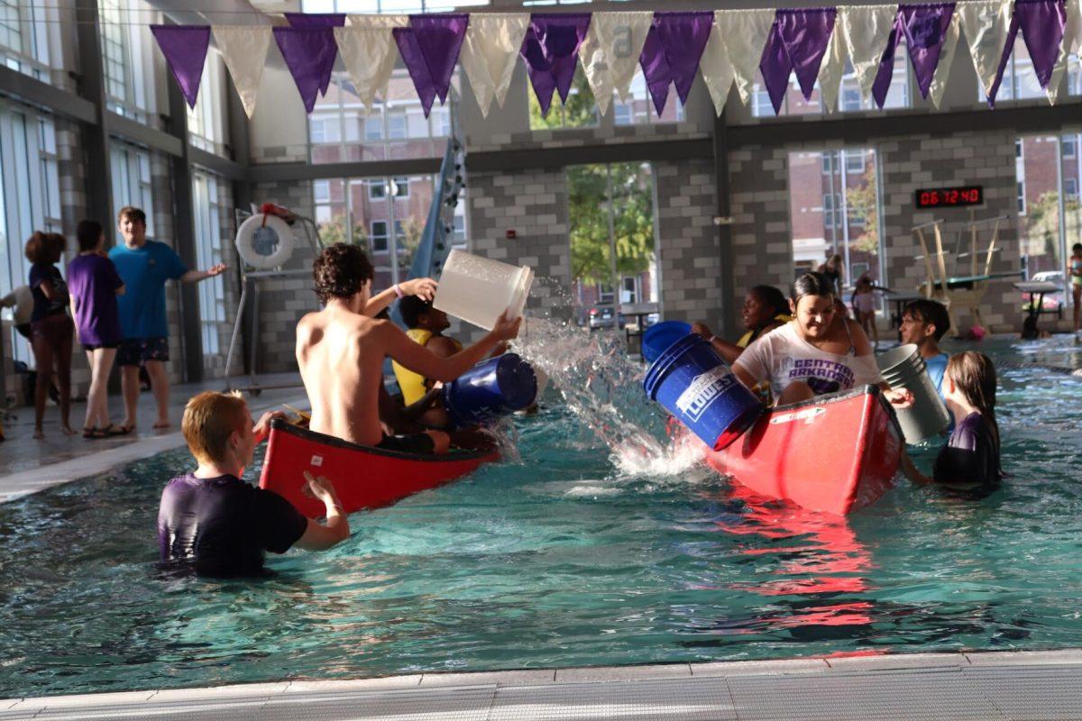 Students attempt to sink their opponents by throwing water from buckets into the opposing canoe. Battleship was hosted by the IDEAL Freshmen leadership team Aug. 26. 