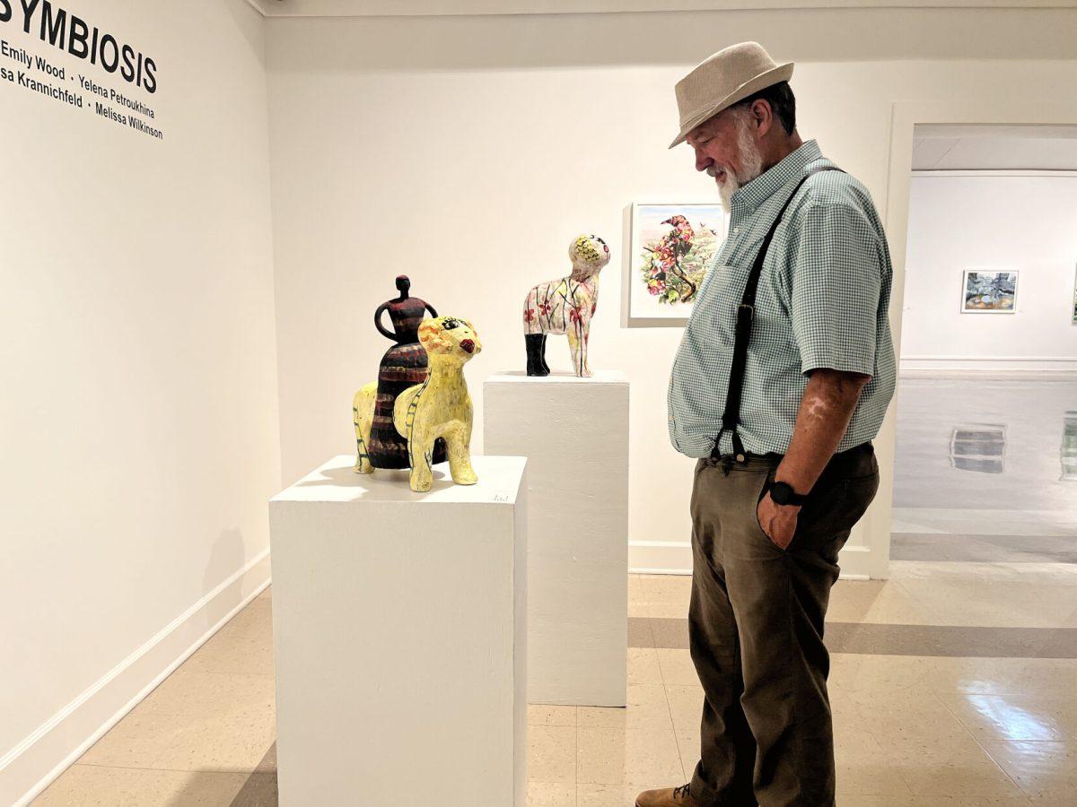 A visitor views "Rider I," a ceramic piece by Yelena Petroukhina. "Vital Signs: Symbiosis" features work from several local artists as well as artists from outside of central Arkansas. 
