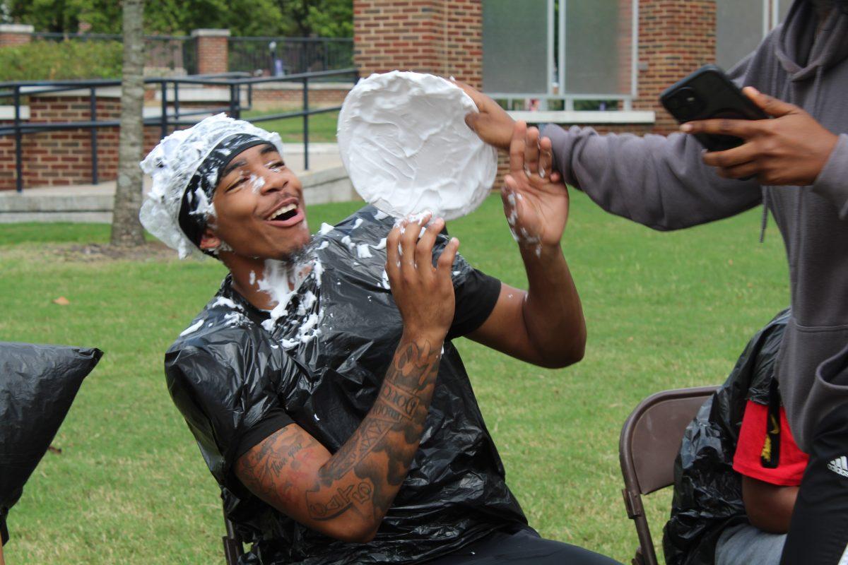 A member of Kappa Alpha Psi gets pied in the face during Kappa Alpha Psi's "Pie a Nupe" event. The event served as a fundraiser for the organization.