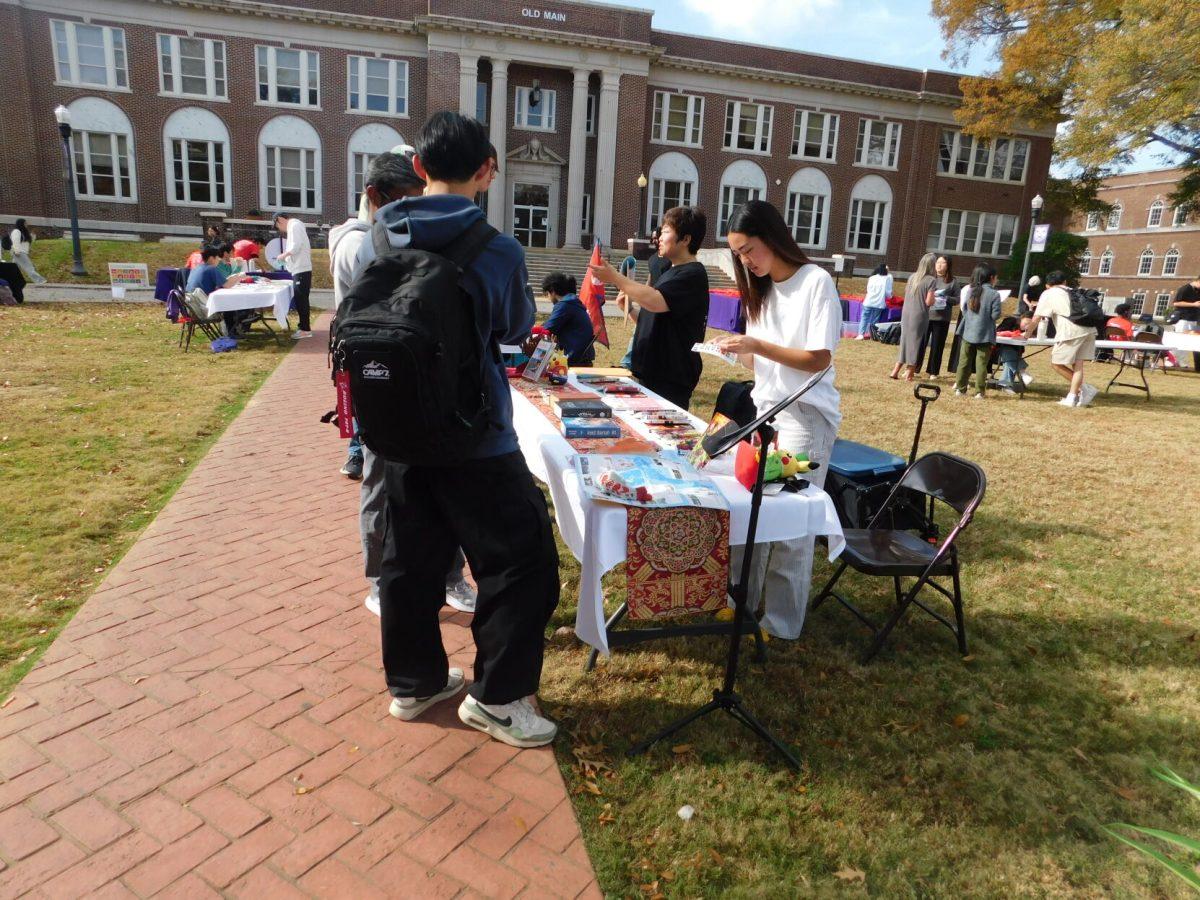 Representatives from the Japanese Club talk to passersby during the Global Expo. The event was one of several different events held to celebrate International Education Week.