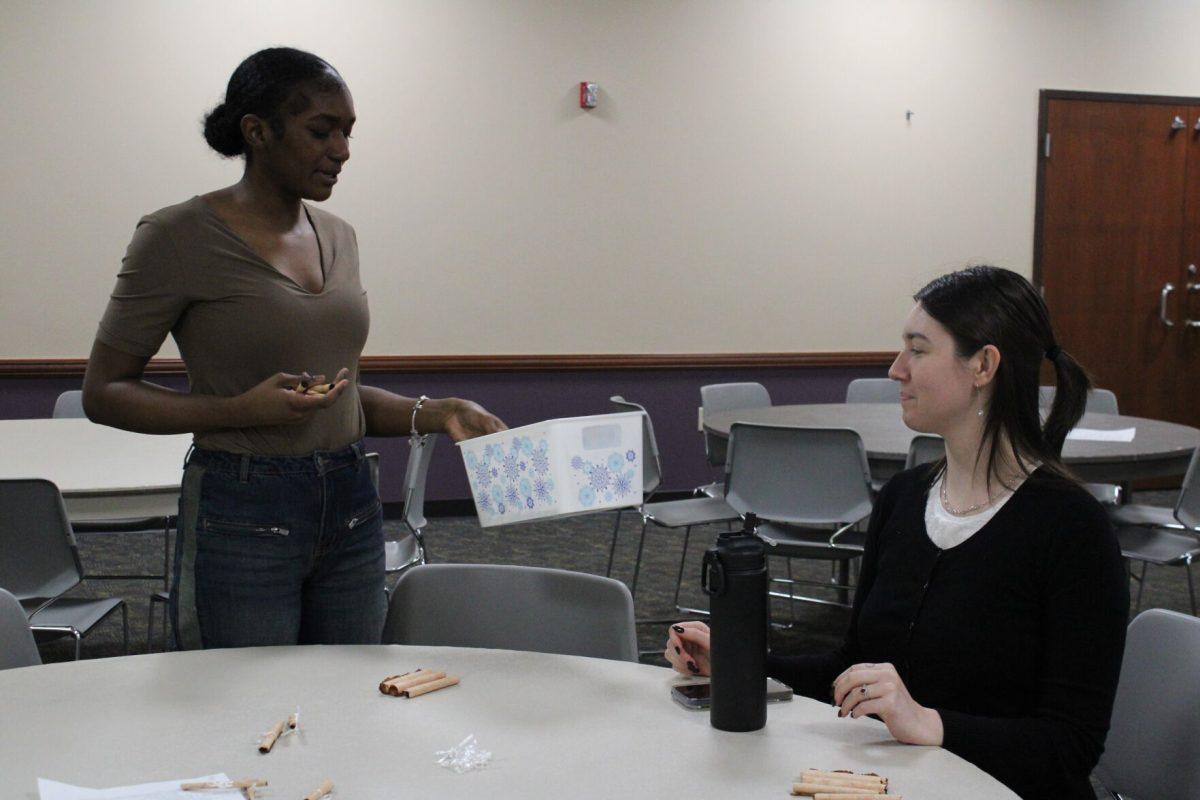 Two students interact during the activity where they were instructed to find another student that met a certain set of criteria. The Student Staff Network hosted the event Nov. 25. 
