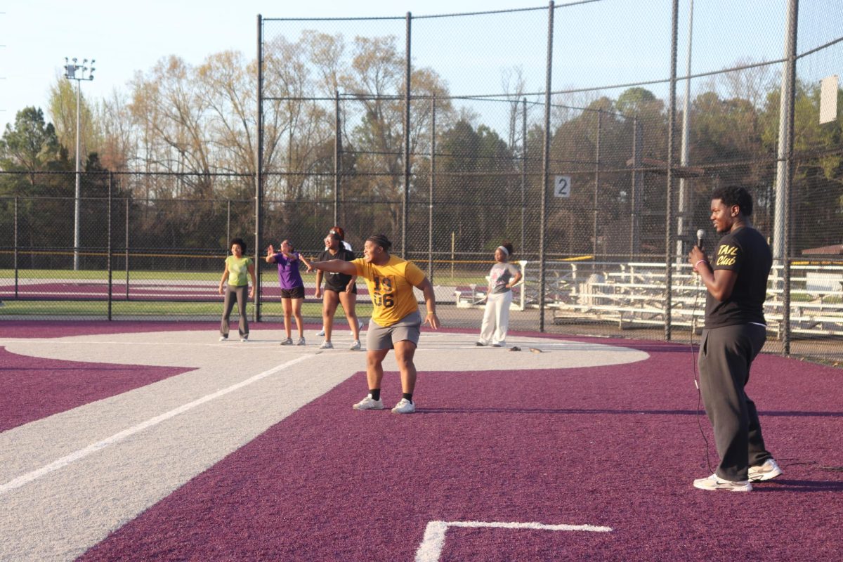 A student cheers on his teammates at Alpha Phi Alpha and Alpha Kappa Alpha's "Phamily Olympics" during the kickball game March 13. The event served as a way for members of these organizations to bond. 