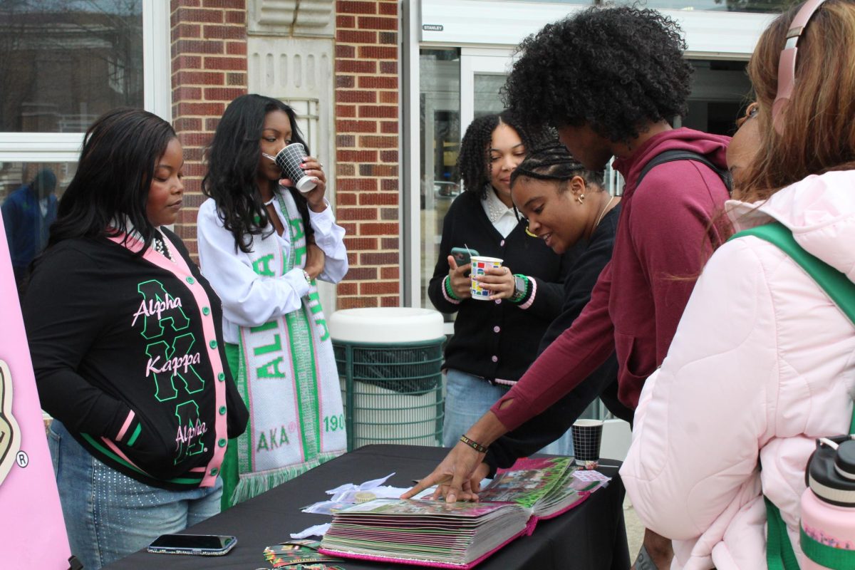 Alpha Kappa Alpha members talk to passersby at their table for their Charter Day promotion event Feb. 24. The sorority celebrated their 52nd Charter Day at the event. 