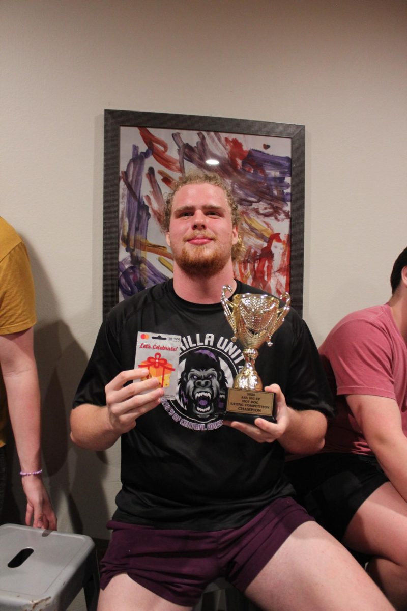 Senior Nick Hazeslip poses with a trophy after winning Alpha Sigma Alpha and Sigma Phi Epsilon's hot dog eating competition Feb. 26. Hazeslip said he has a background in competitive eating. 